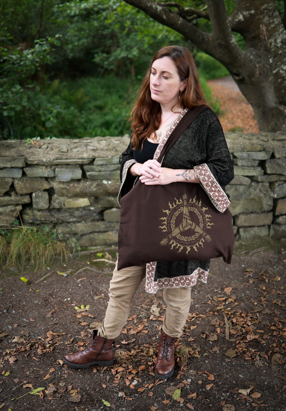 Brigid Celtic tote bag worn over the shoulder, showing the printed knotwork design and practical everyday size.