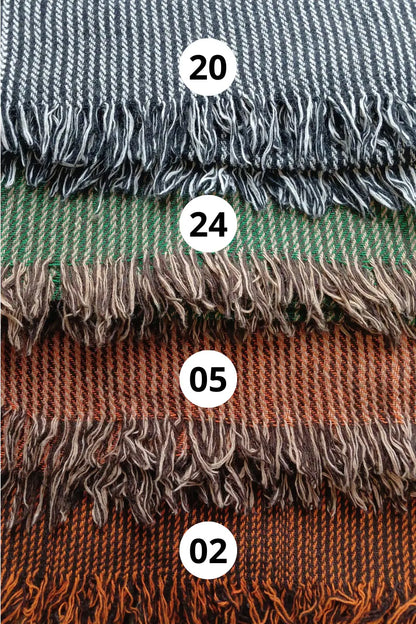 Handwoven shawl swatch options in grey, green and rust tones, showing striped wool blend weave and fringe detail by Celtic Fusion