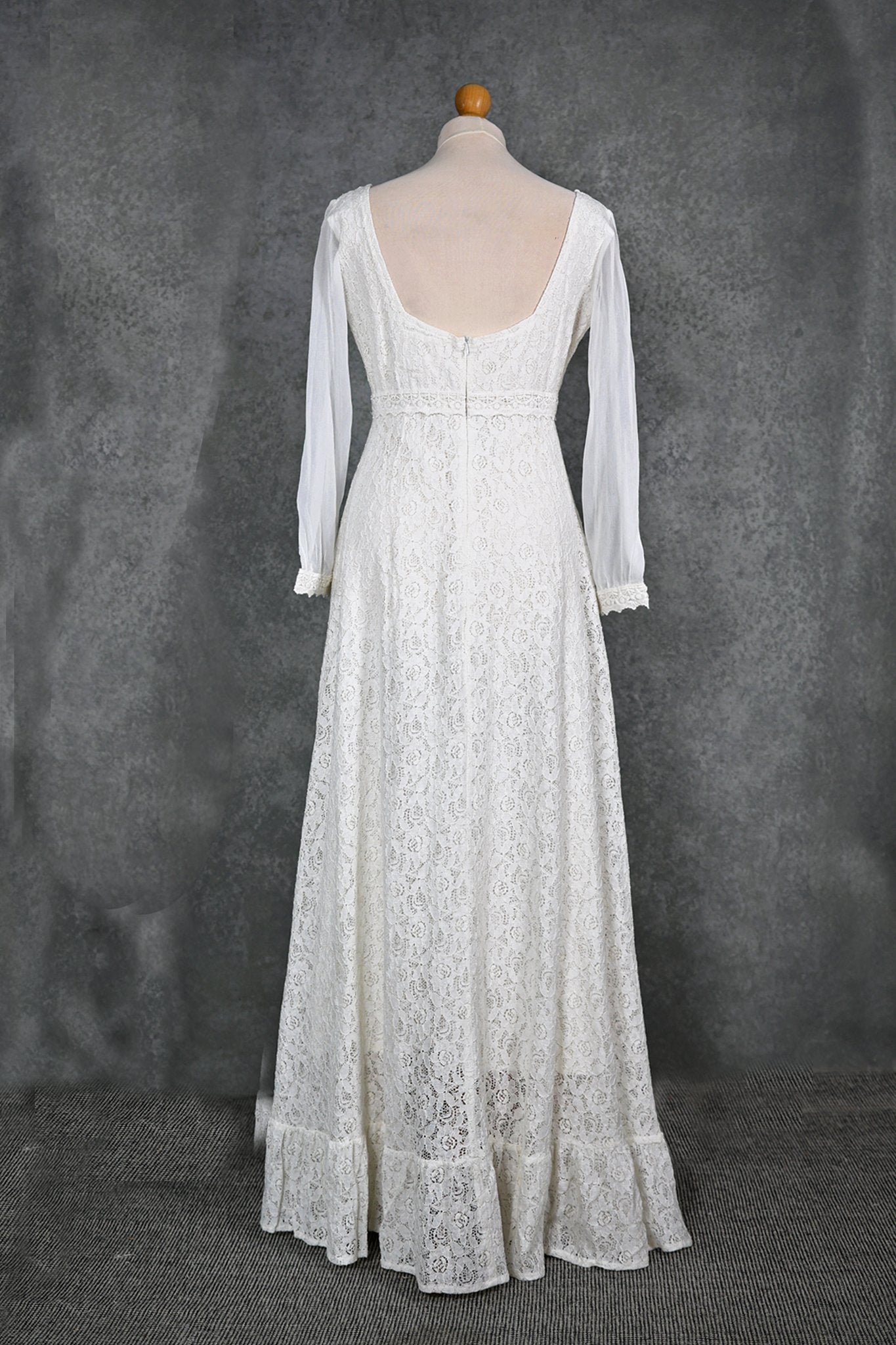 Annagh cotton lace wedding dress on mannequin with low V back, lace sleeves and softly flared skirt