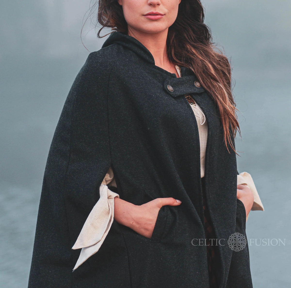 Close-up of black felt wool cape showing hood, front fastening and pocket detail with folklore style by celtic fusion