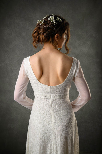 Close-up of Annagh Celtic bridal gown with sleeves showing low rounded back, lace bodice and sheer chiffon sleeves