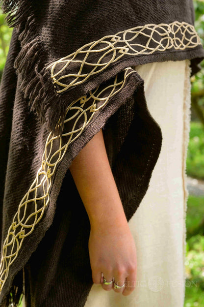 close up of golden embroidered celtic knotwork on wool blend brown handwoven celtic cape