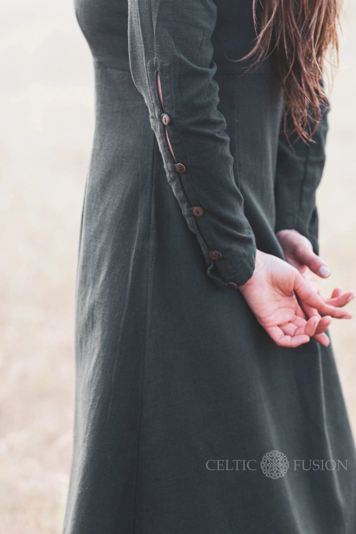 Detail of sleeve buttons on a green Celtic dress, showing the craftsmanship of this breathable long sleeve folklore dress.