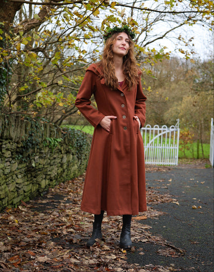 Rust Princess autumn coat styled for folklore-inspired winter wear with button front and practical pockets