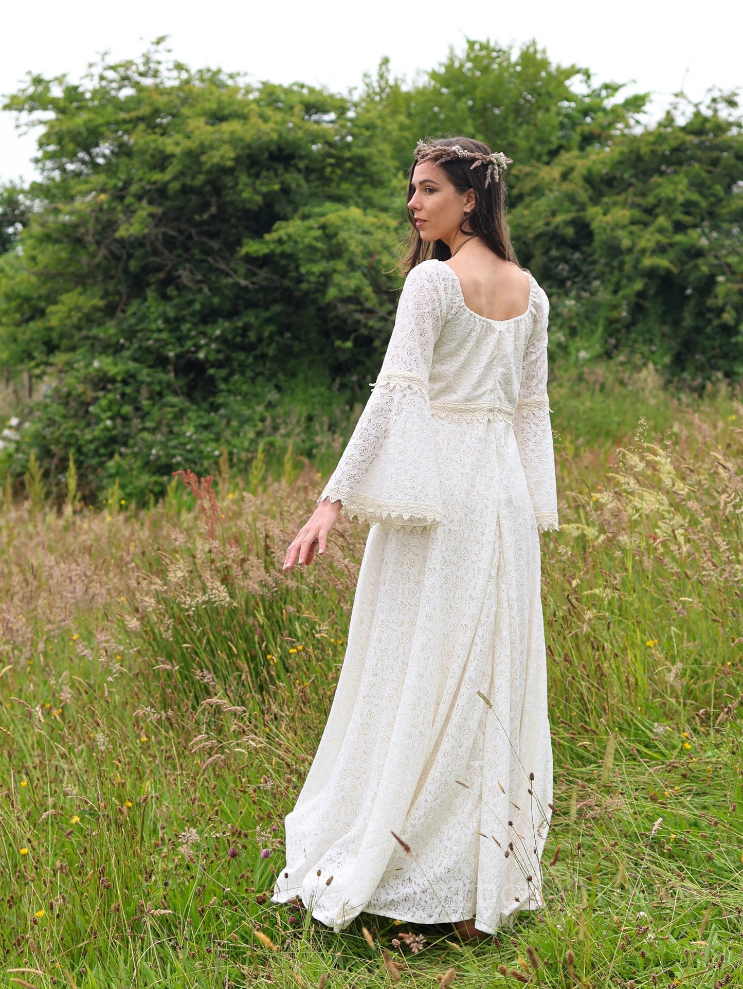 Irish Celtic bridal gown back view outdoors, Bébhinn Boho Lace Wedding Dress in sustainable cotton lace with flowing skirt.