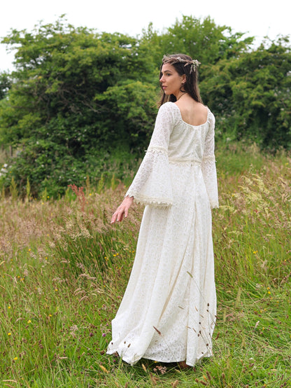 Irish Celtic bridal gown back view outdoors, Bébhinn Boho Lace Wedding Dress in sustainable cotton lace with flowing skirt.