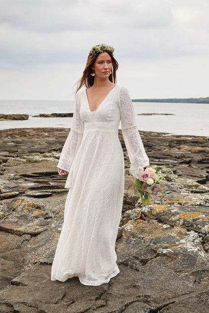 Ivory cotton natural wedding gown with sleeves and soft flowing skirt worn for a coastal bridal look in Ireland designed by Celtic Fusion