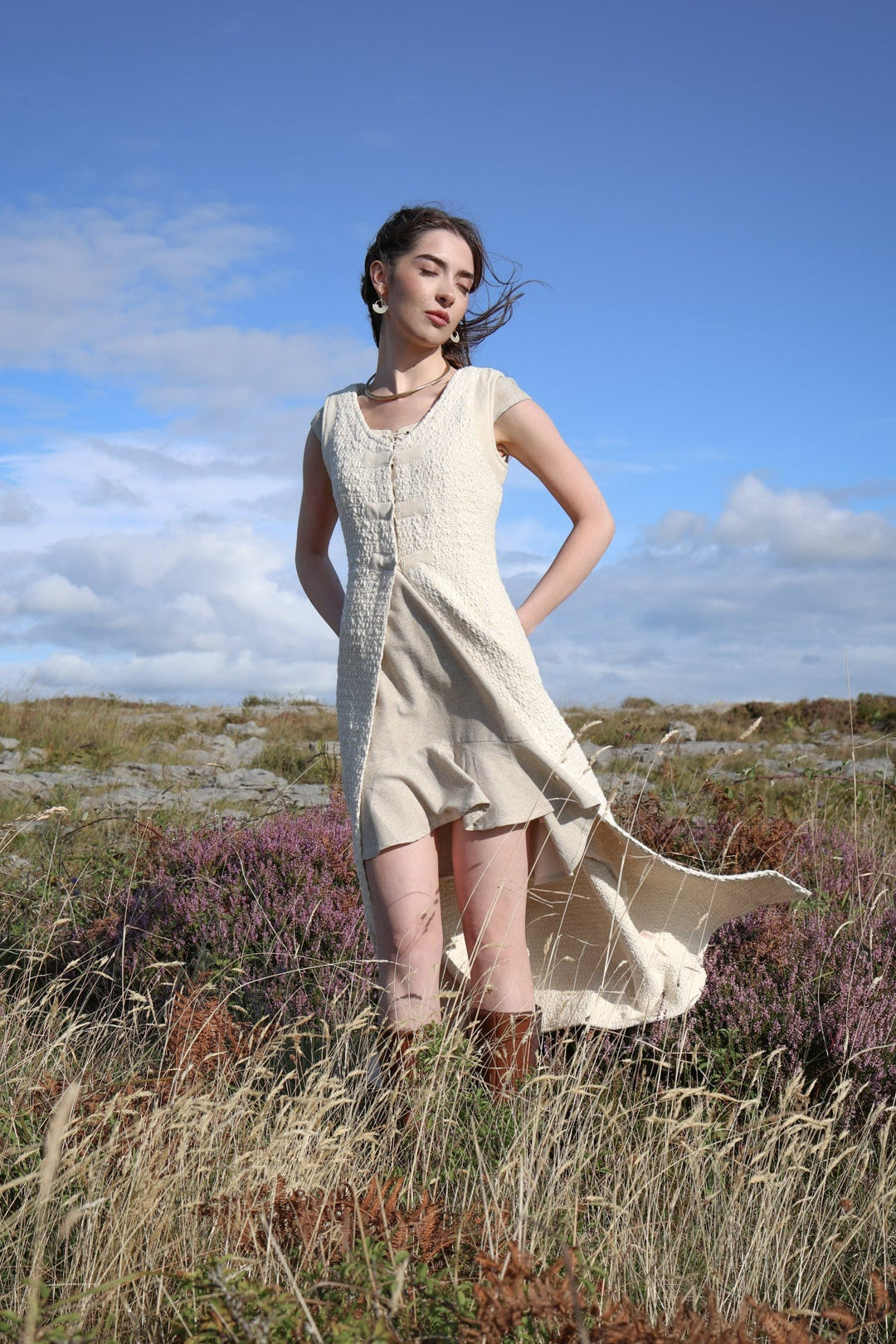 Ivory long layering waistcoat with open front, textured fabric and fitted corset-style upper body.