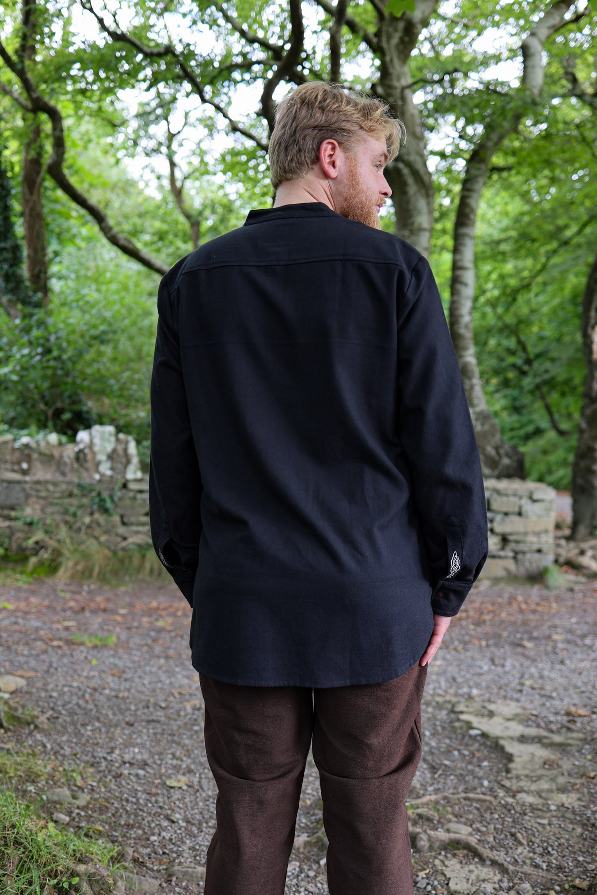 Men’s black grandfather collar shirt showing the clean longline back, textured cotton fabric and relaxed fit.