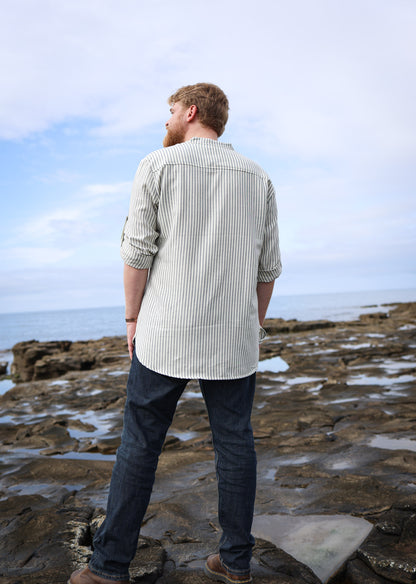 Men’s striped grandfather collar shirt in cream and blue cotton, shown from the back with rolled sleeves and a relaxed longline fit.