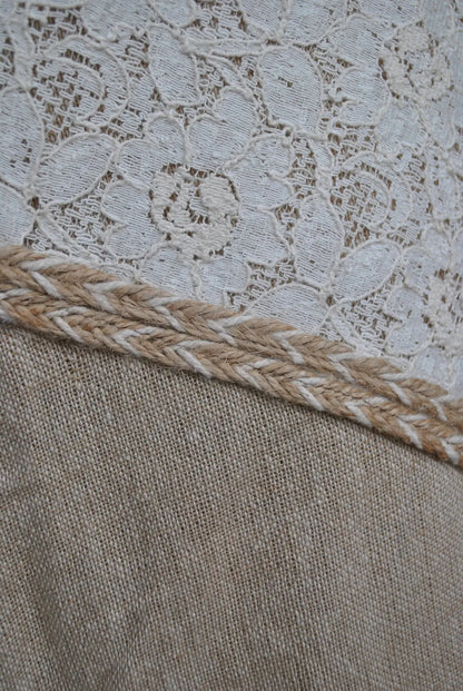 Close-up of Banda skirt showing cotton lace panel, natural jute blend fabric and braided trim detail