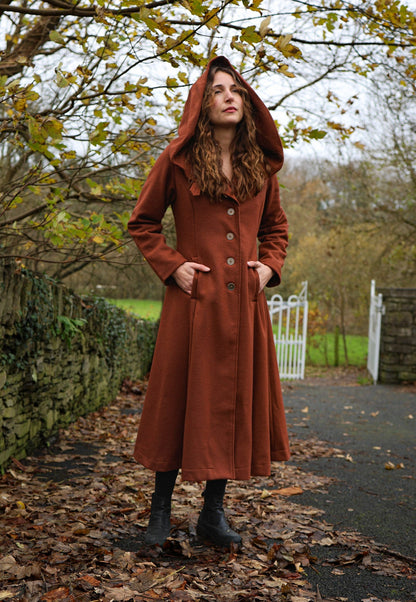 Rust wool blend maxi coat with oversized hood, cinched waist, full flowing skirt and pockets. A witchy fairytale-inspired coat for autumn and winter.