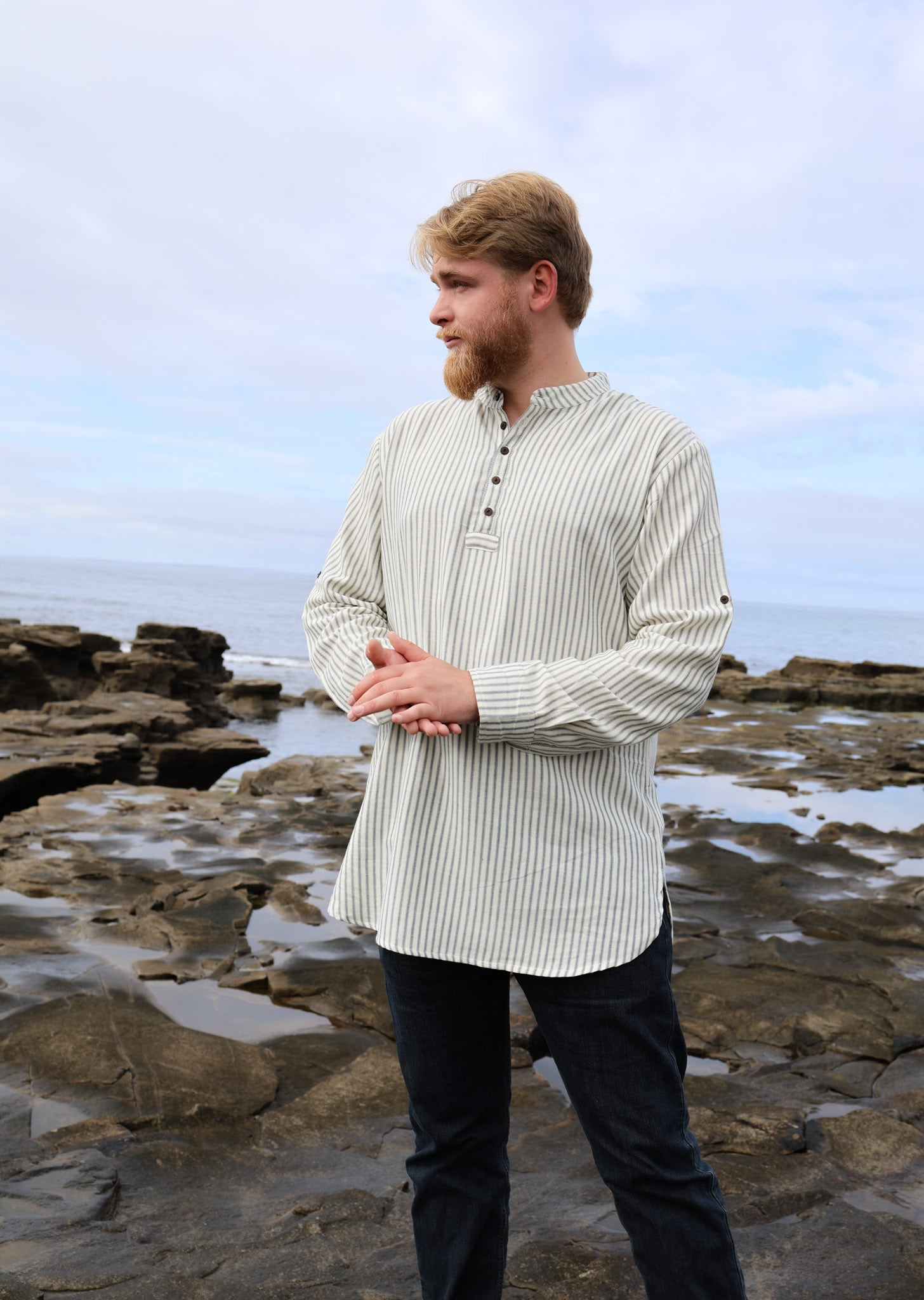 Striped fisherman shirt for men with grandfather collar, short button placket and roll-tab sleeves in cream and blue cotton designed by Celtic Fusion.