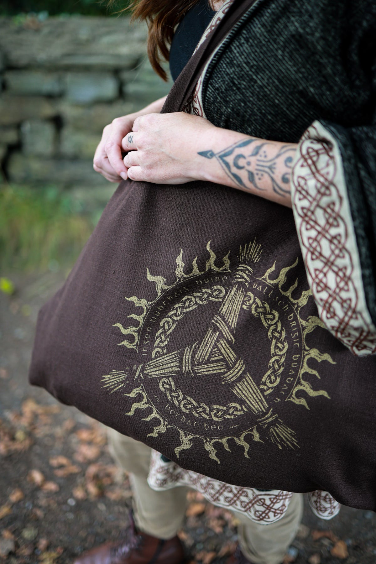 Upcycled brown tote bag featuring Goddess Brigid-inspired Irish folklore artwork and contrasting Celtic print.
