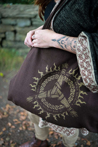 Upcycled brown tote bag featuring Goddess Brigid-inspired Irish folklore artwork and contrasting Celtic print.