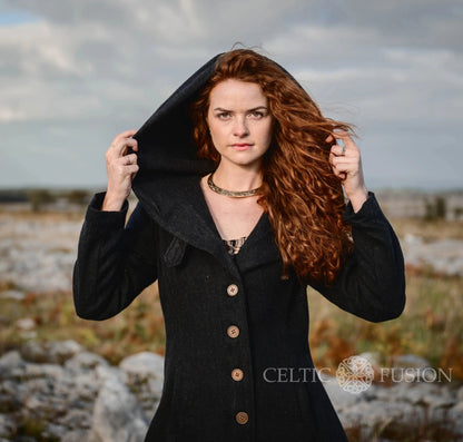 Close-up of black Princess wool coat with oversized hood, fitted bodice and statement button front created by Celtic Fusion folklore designs