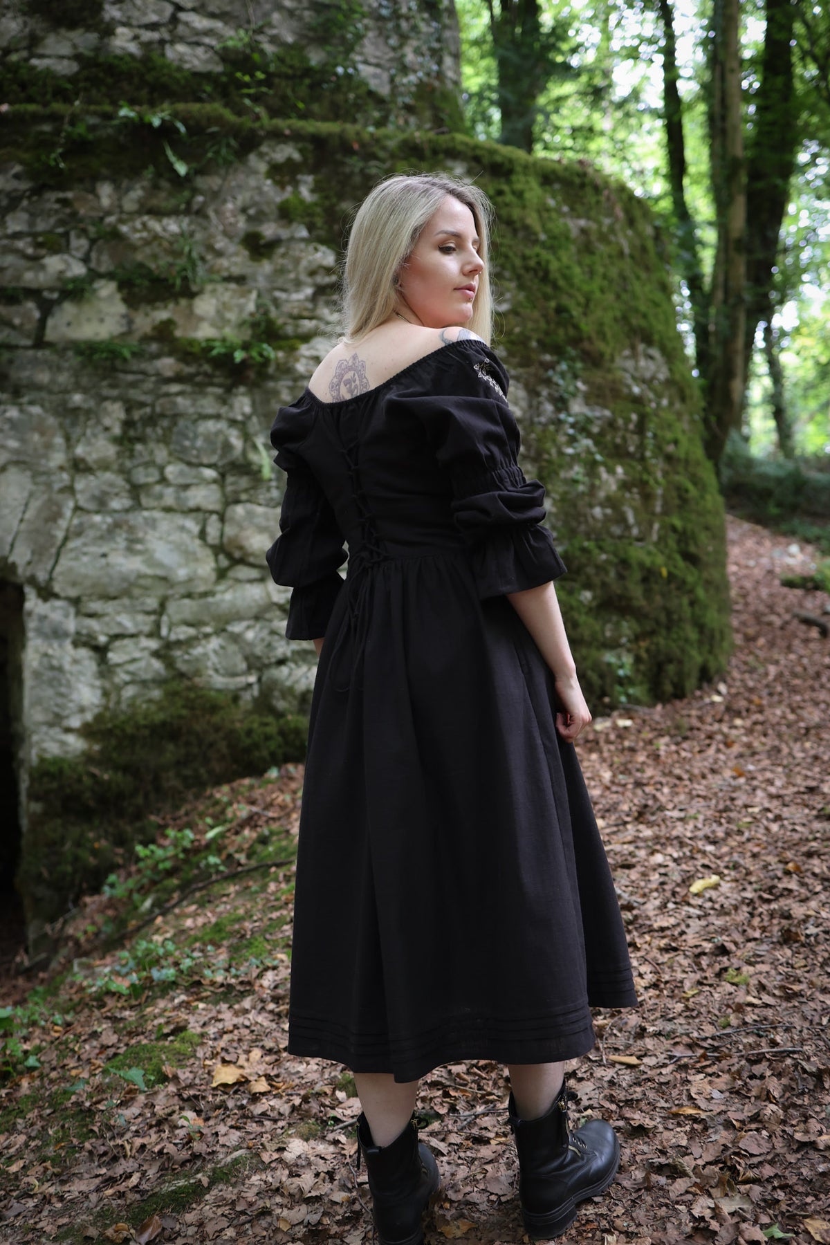 Fiadh black corset back midi dress with adjustable lace-up waist, gathered sleeves, flowing cotton skirt and pockets.
