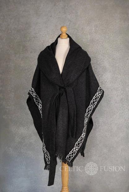 Front view of black wool blend Druid cape celtic design on mannequin with oversized hood, belt and Celtic knot embroidery