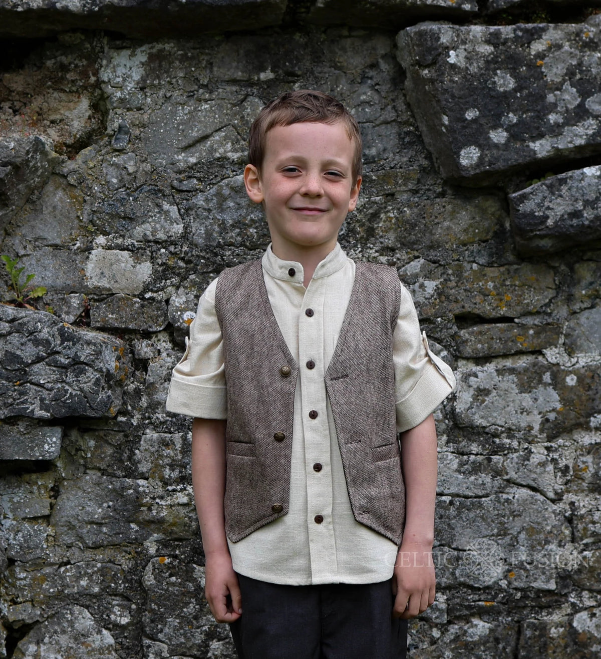Front view of boys brown tweed Celtic waistcoat with button fastening, welt pockets and V neckline