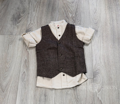 Flat lay of boys brown tweed waistcoat over cream shirt showing front buttons, pockets and pointed hem
