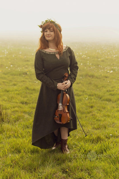 Marin green Celtic dress with Celtic knot embroidery, styled as a breathable long sleeve folklore dress and alternative wedding guest dress with high low skirt.