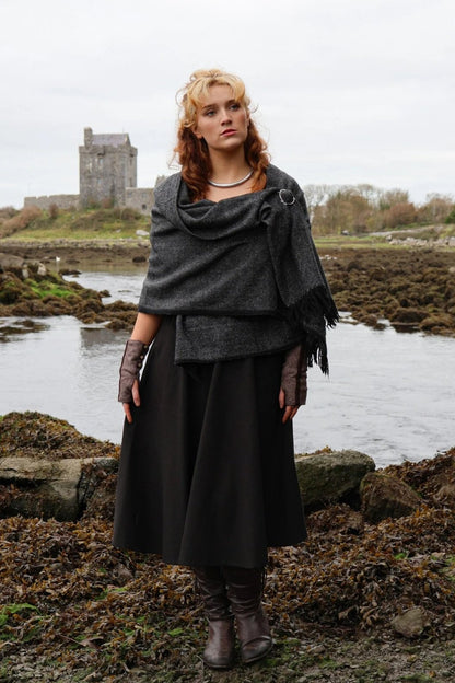 Full-length view of handwoven shawl styled with white metal Uisneach brooch in an Irish nature setting