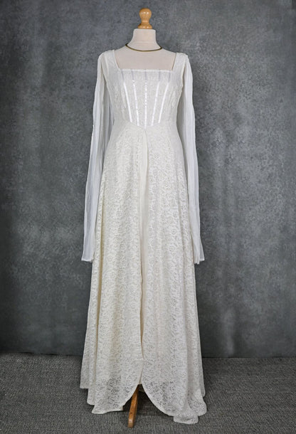 Celtic Fusion romantic wedding dress on mannequin with square neckline, corset-style bodice and long chiffon drape sleeves