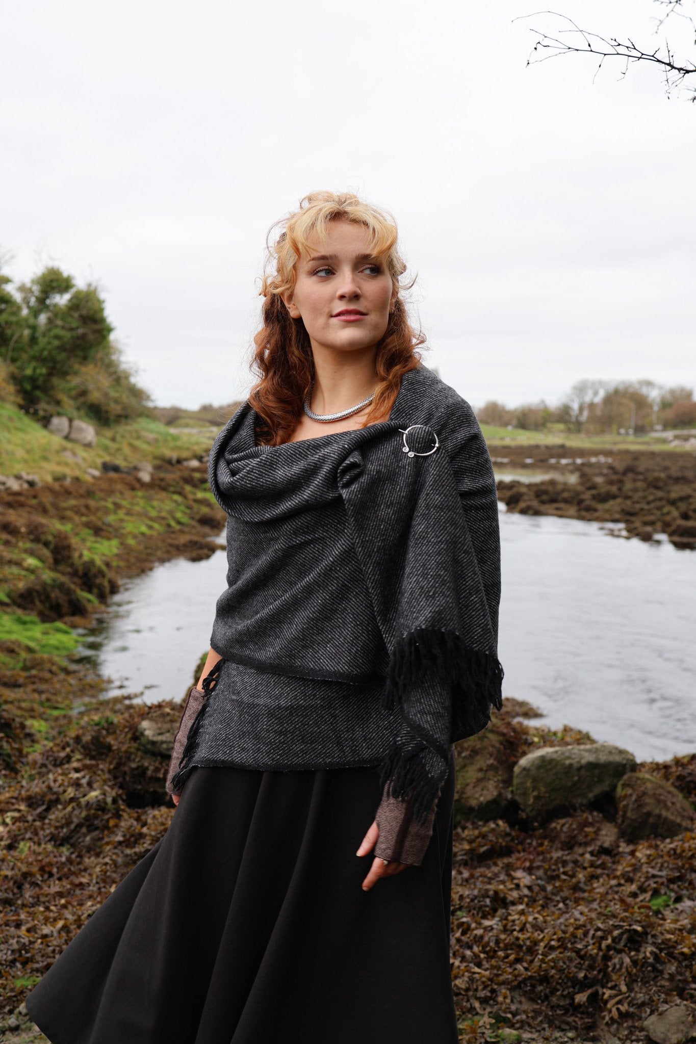 Irish-inspired handwoven shawl fastened with white metal Uisneach brooch and styled for everyday folklore wear