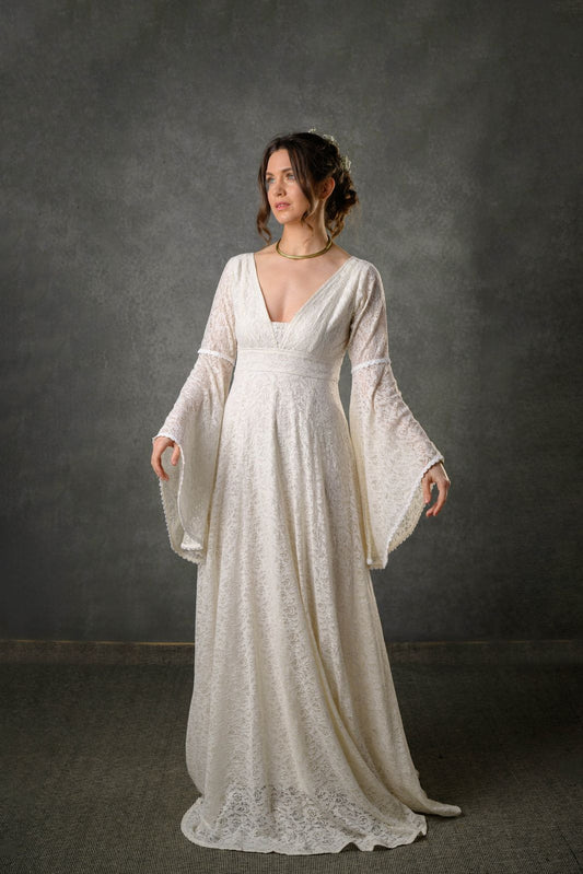 Ivory cotton lace bell sleeve wedding dress with fitted waist and plunging V neckline designed by Celtic Fusion