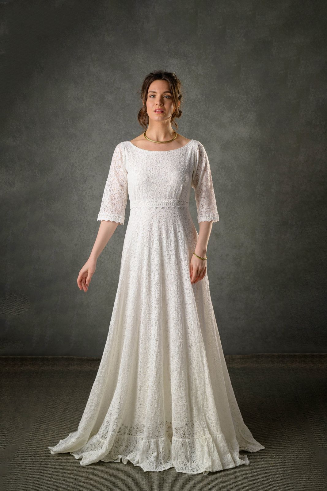 Ivory lace Celtic bridal gown with three quarter sleeves, bateau neckline and full-length flowing skirt