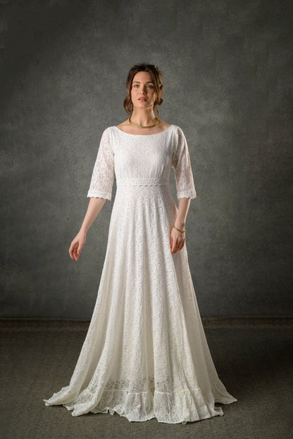 Ivory lace Celtic bridal gown with three quarter sleeves, bateau neckline and full-length flowing skirt