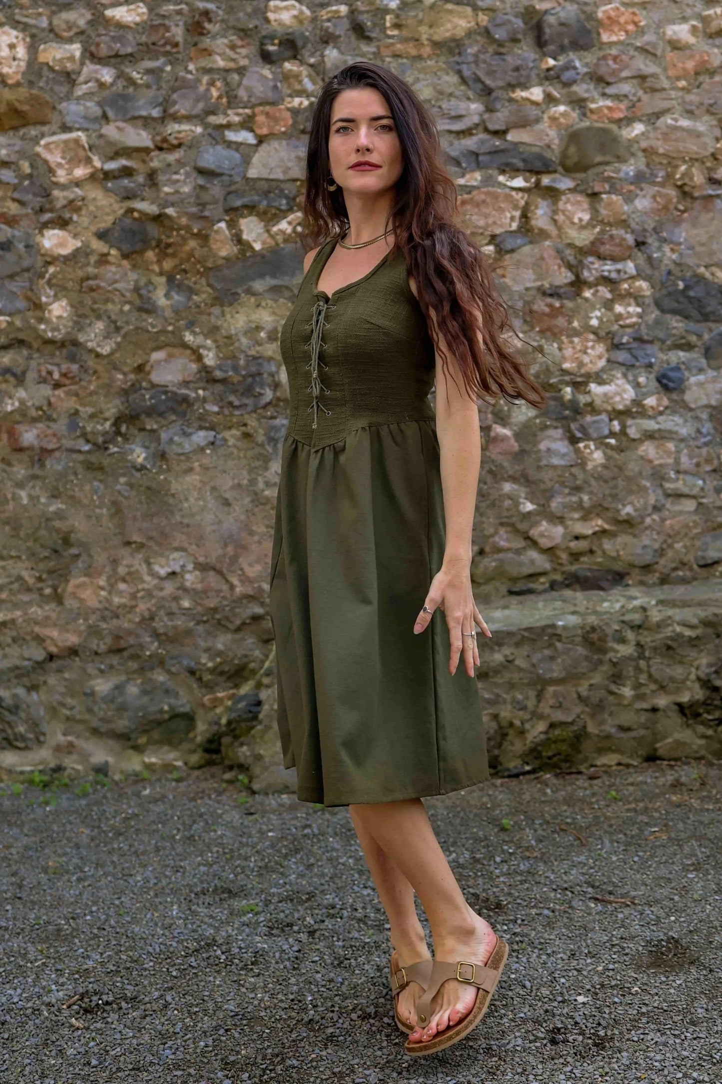 Dark green folklore dress with pockets in a Green Corset Dress design, shown from the front with a flowing midi skirt.