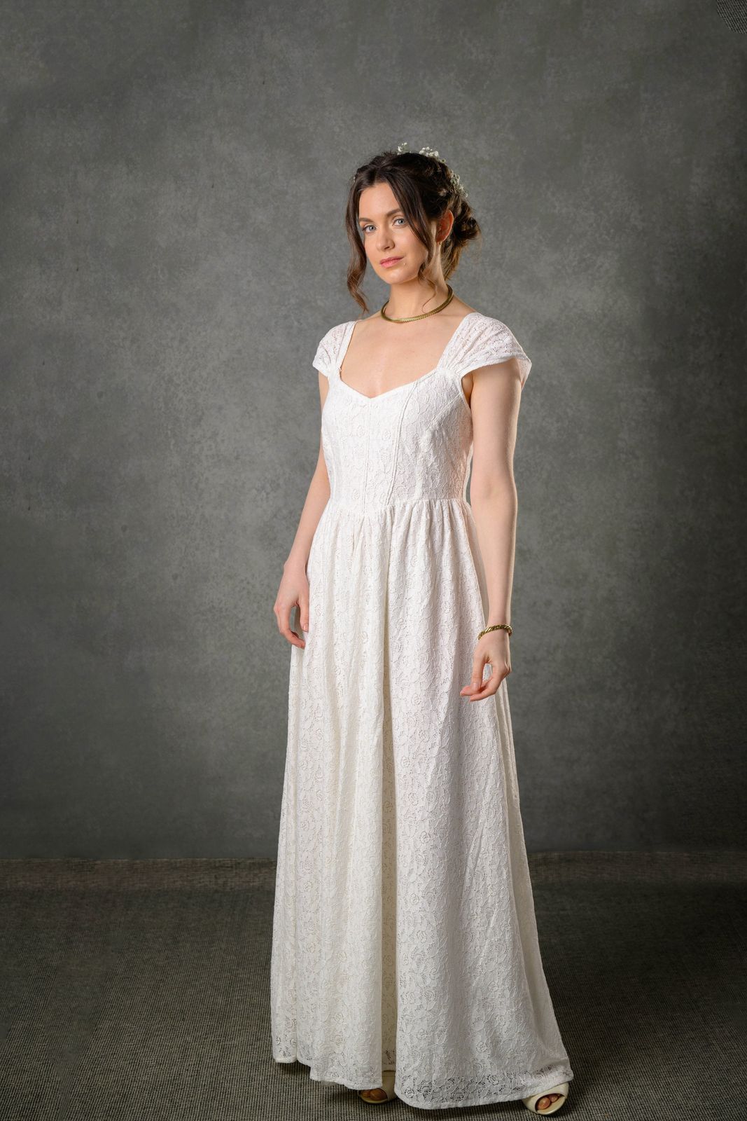 Floral cotton lace gown for bride with fitted corset bodice, gathered straps and romantic ivory silhouette