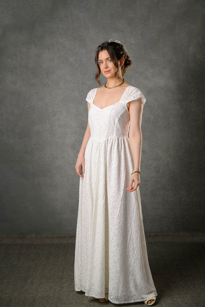 Floral cotton lace gown for bride with fitted corset bodice, gathered straps and romantic ivory silhouette