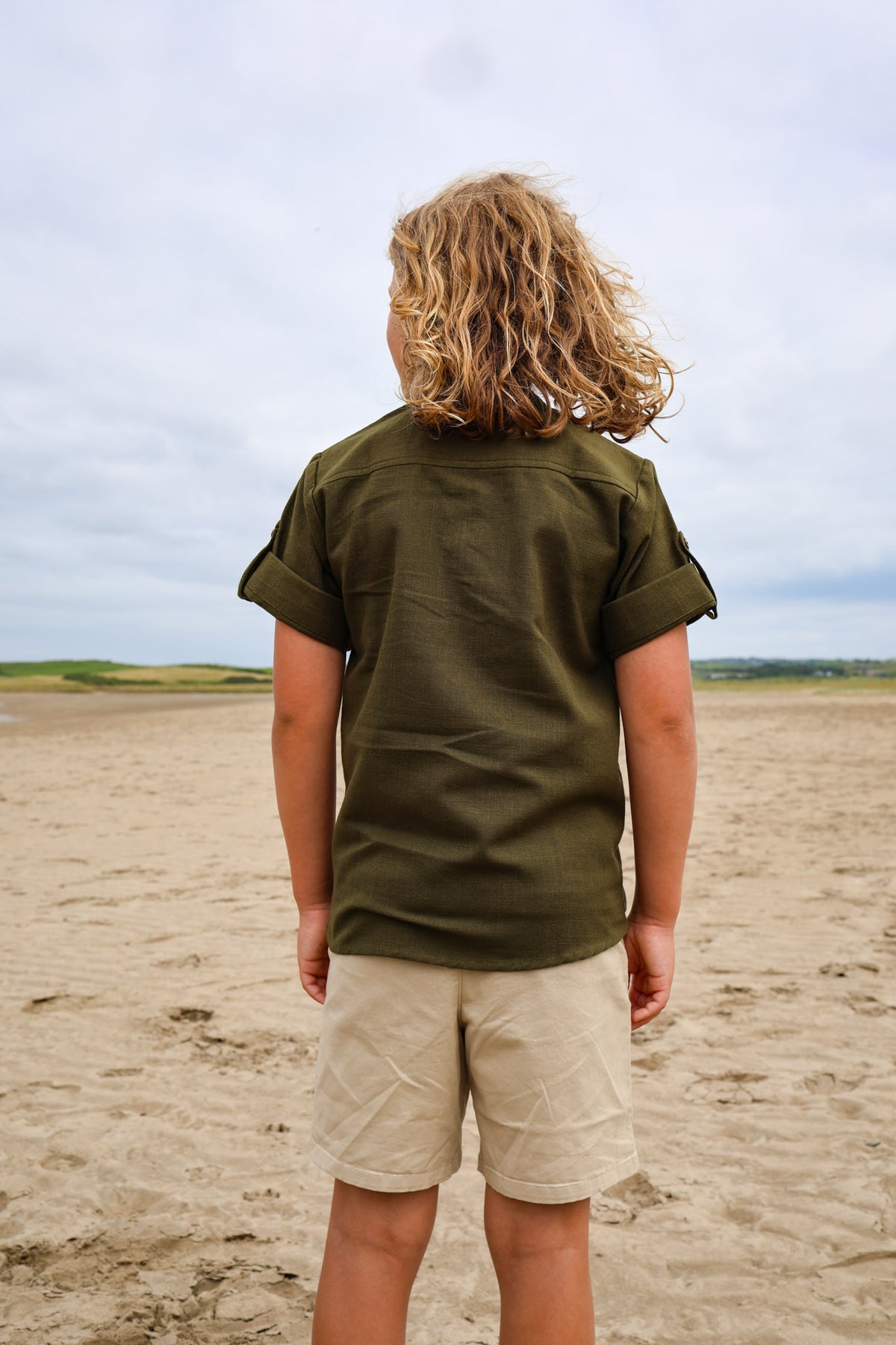 Back view of olive green Boys Celtic Medieval Shirt with relaxed fit and practical roll-up sleeves.