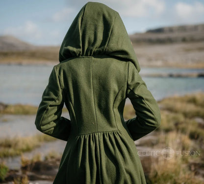 Back view of green romantic folklore coat showing oversized hood, cinched waist and full flowing skirt