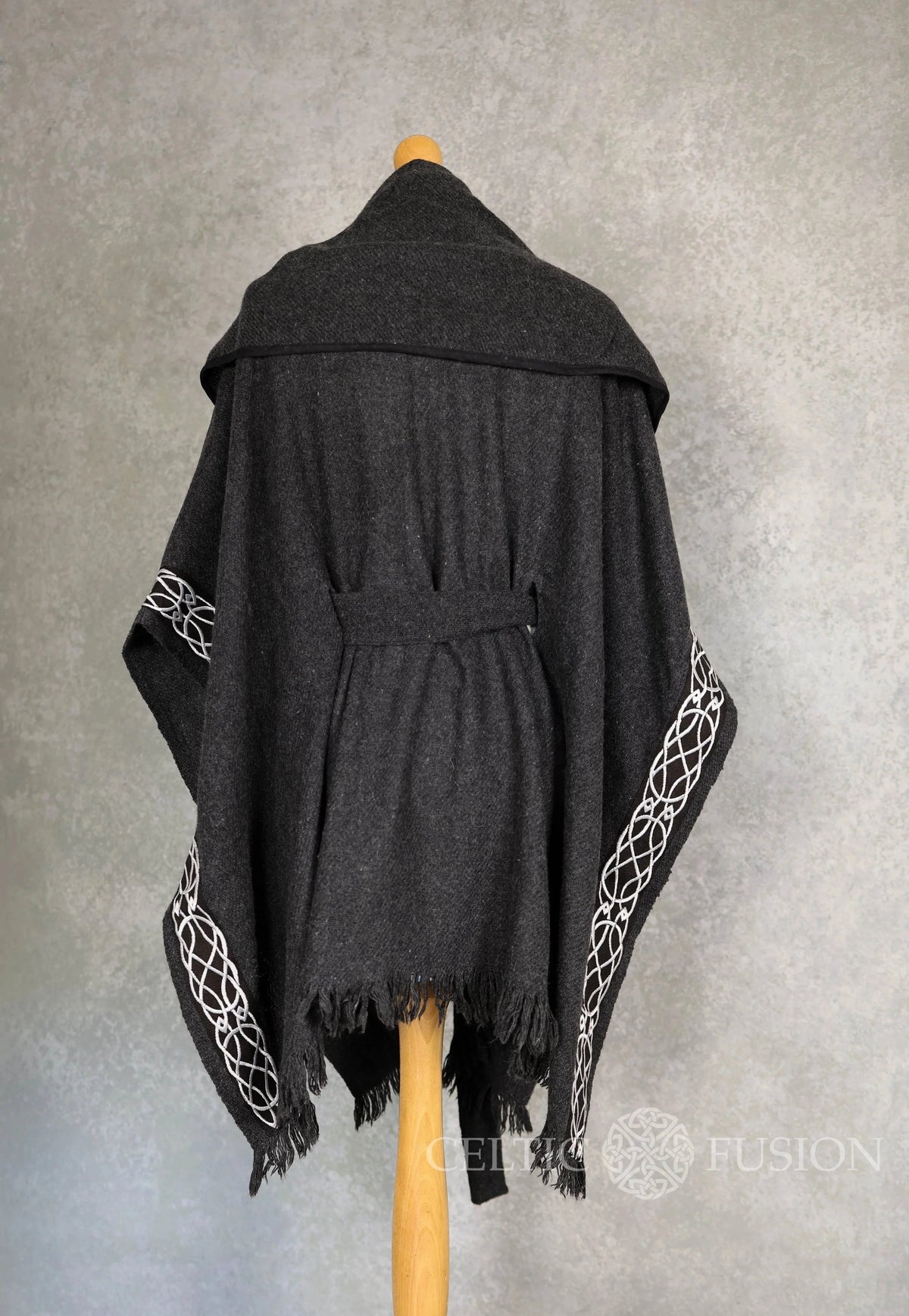 Back view of charcoal black Druid cape showing large hood, belted waist and Celtic embroidered edging