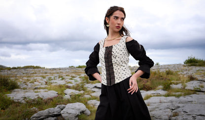 maple leaf layered folk corset over black dress in burren landscape