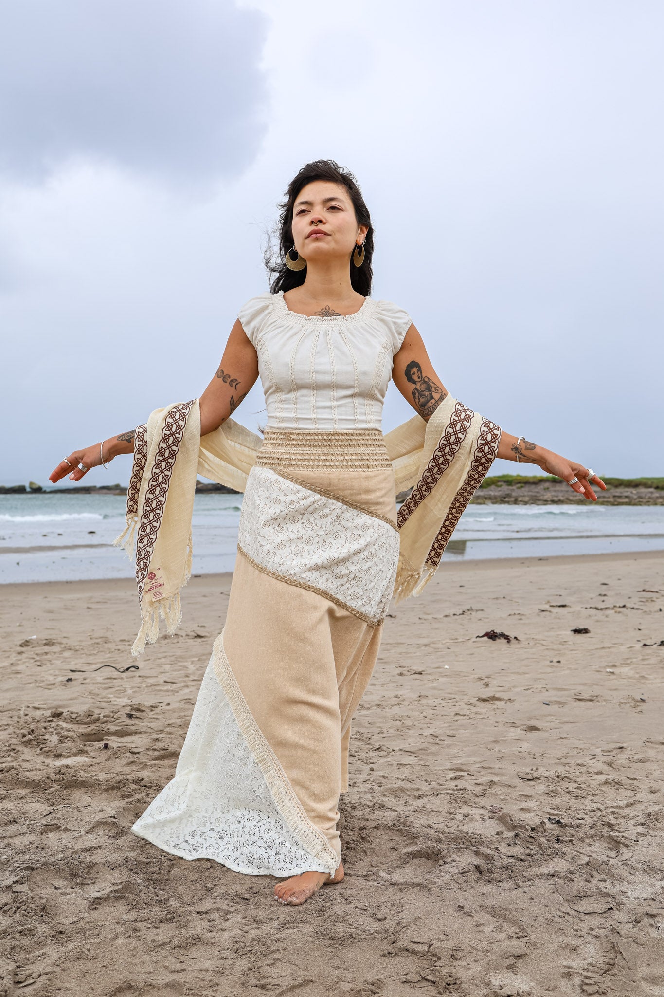 Natural fibre patchwork maxi boho skirt in cotton lace and jute worn on the beach with embroidered shawl