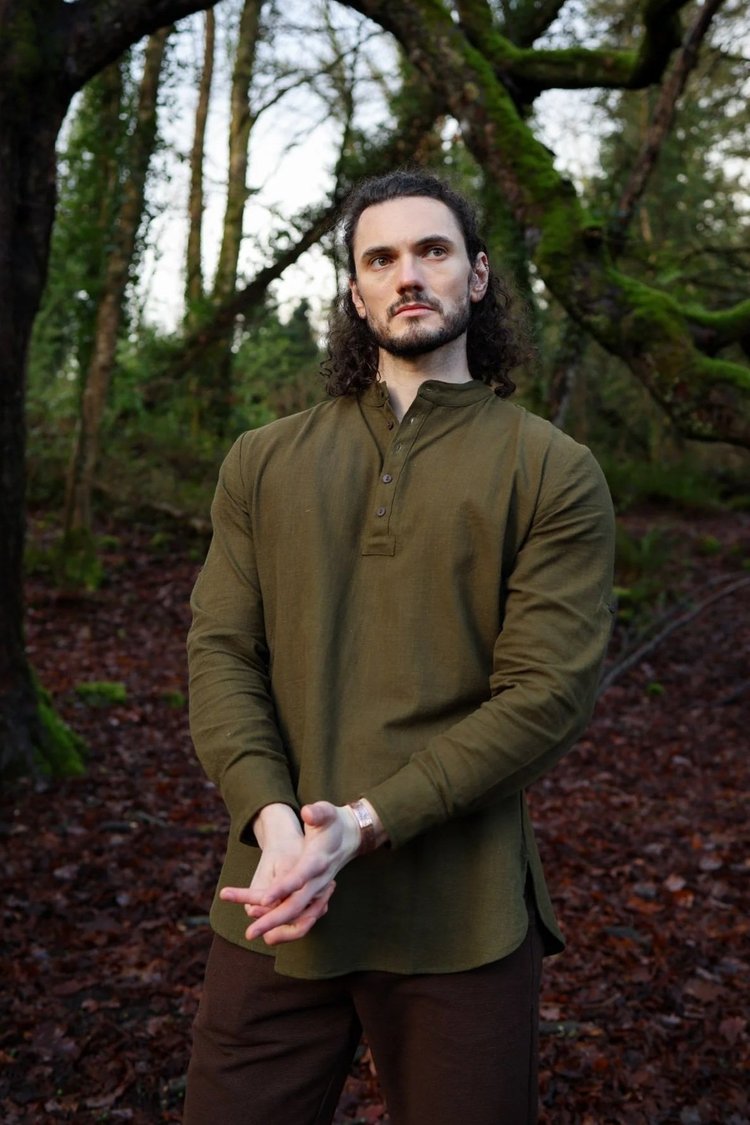 Men’s forest green grandad collar shirt with button placket in a woodland setting