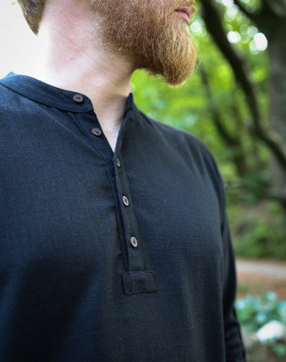 Close up quater button detail of black grandfather collarless shirt crafted in quality heavy cotton