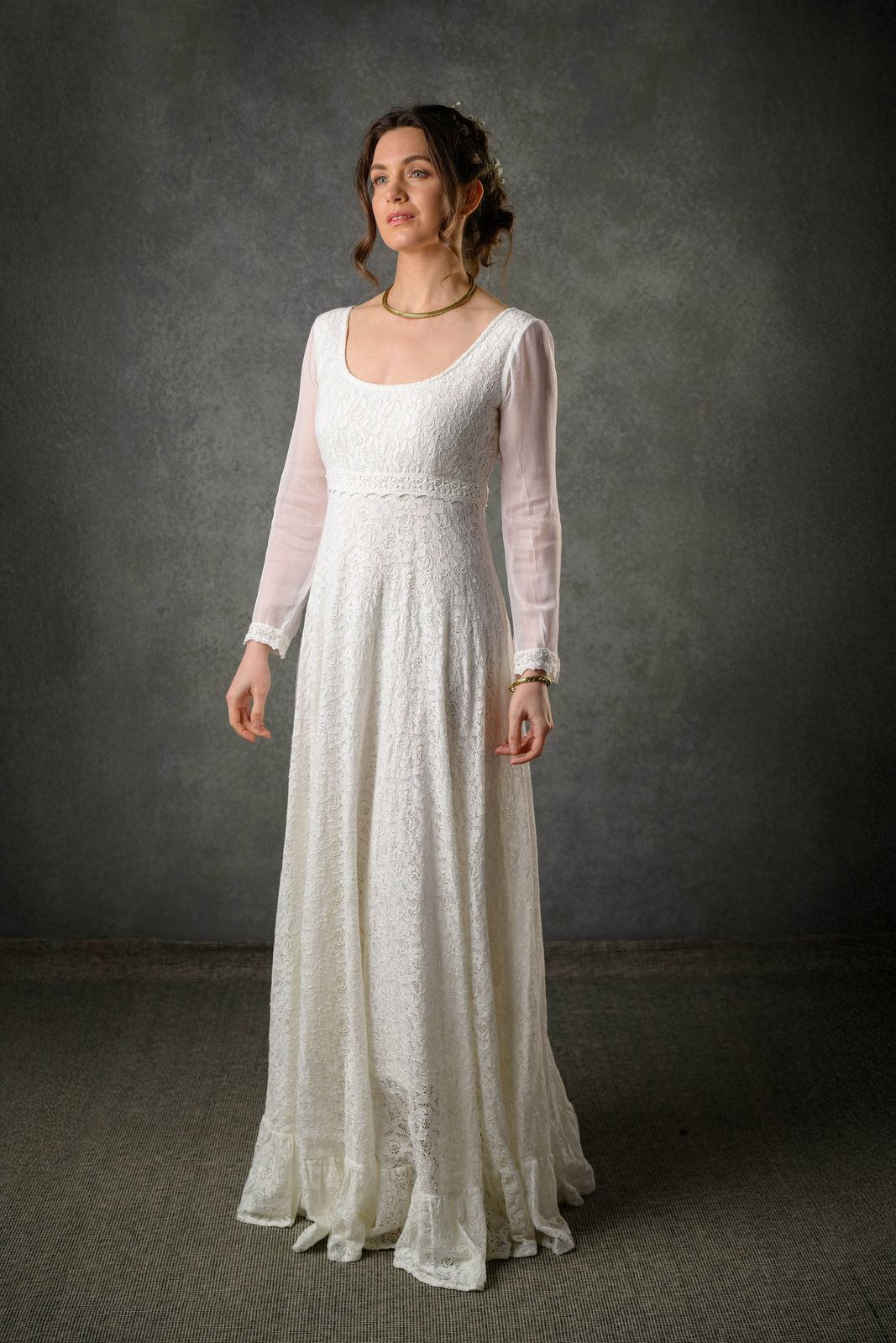 Ivory regency style wedding dress with lace bodice, sheer long sleeves and romantic full-length skirt