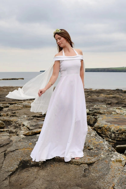 Modern ivory romantic wedding gown with soft off shoulder neckline and draped chiffon sleeves