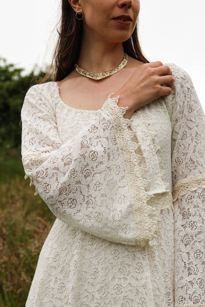 Detail of the Bébhinn Boho Lace Wedding Dress showing sustainable cotton lace, romantic bell sleeve, and bridal texture close-up.