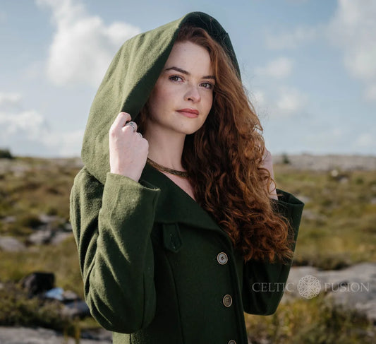 Close-up of romantic green wool coat showing oversized hood, button front and tailored folklore-inspired fit